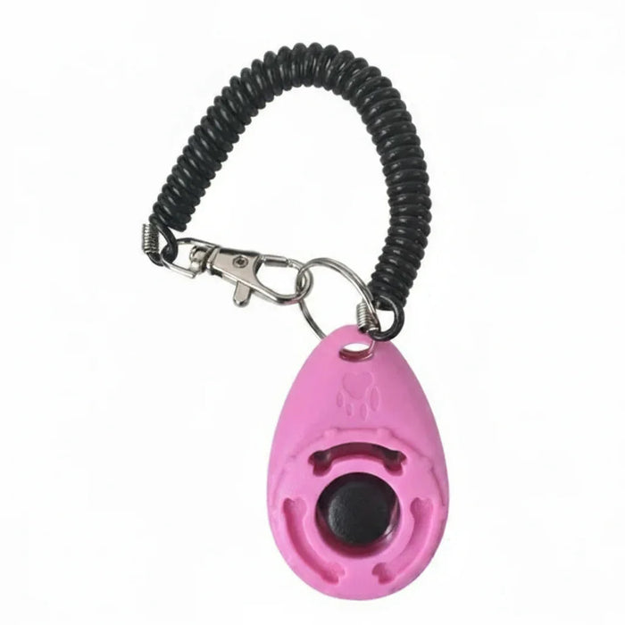 Clicker de adestramento rosa para cães com pulseira espiral preta e mosquetão metálico.
